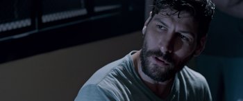 Movie still from “Notorious Nick” (2021), directed by Aaron Leong – A person with a beard; Close Up shot, Over the shoulder angle