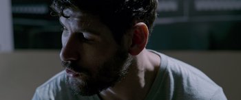 Movie still from “Notorious Nick” (2021), directed by Aaron Leong – A person with a beard; Close Up shot, Low angle