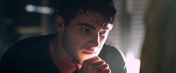 Movie still from “Notorious Nick” (2021), directed by Aaron Leong – A person with his hand under his chin; Close Up shot, Low angle