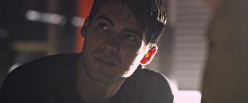 Movie still from “Notorious Nick” (2021), directed by Aaron Leong – A man's face in the dark; Close Up shot, Low angle