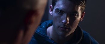 Movie still from “Notorious Nick” (2021), directed by Aaron Leong – A man's face in the dark; Close Up shot, Over the shoulder angle