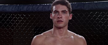 Movie still from “Notorious Nick” (2021), directed by Aaron Leong – A young man in a boxing ring with his eyes closed; Close Up shot, Low angle