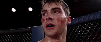 Movie still from “Notorious Nick” (2021), directed by Aaron Leong – A man's face in a boxing ring; Close Up shot, Low angle