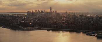Movie still from “Now You See Me” (2013), directed by Louis Leterrier – A view of a large city from a helicopter at sunset; Extreme Wide shot, High angle