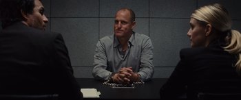 Movie still from “Now You See Me” (2013), directed by Louis Leterrier – A man sitting at a table with his hands chained to his chest; Medium shot, Over the shoulder angle