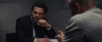 Movie still from “Now You See Me” (2013), directed by Louis Leterrier – A man sitting at a table talking to another man; Close Up shot, Over the shoulder angle