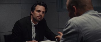 Movie still from “Now You See Me” (2013), directed by Louis Leterrier – A man sitting at a table talking to another man; Close Up shot, Over the shoulder angle