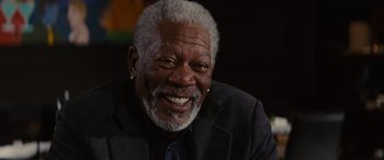 Movie still from “Now You See Me” (2013), directed by Louis Leterrier – An older man smiling for the camera; Close Up shot, Low angle