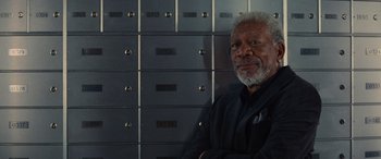 Movie still from “Now You See Me” (2013), directed by Louis Leterrier – An older man sitting in front of a row of mailboxes; Close Up shot, Low angle