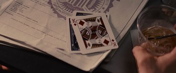 Movie still from “Now You See Me” (2013), directed by Louis Leterrier – Two playing cards on top of papers; Extreme Close Up shot, Overhead angle