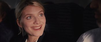 Movie still from “Now You See Me” (2013), directed by Louis Leterrier – A woman smiling for the camera; Close Up shot, Over the shoulder angle