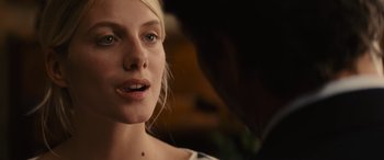 Movie still from “Now You See Me” (2013), directed by Louis Leterrier – A woman's face in a dark room; Close Up shot, Over the shoulder angle