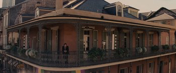 Movie still from “Now You See Me” (2013), directed by Louis Leterrier – A man standing on the balcony of a building; Extreme Wide shot, High angle