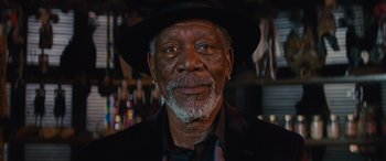 Movie still from “Now You See Me” (2013), directed by Louis Leterrier – An older man wearing a black hat and a black jacket; Close Up shot, Low angle