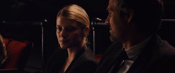 Movie still from “Now You See Me” (2013), directed by Louis Leterrier – A man and a woman sitting next to each other in front of a microphone; Close Up shot, Over the shoulder angle