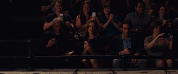 Movie still from “Now You See Me” (2013), directed by Louis Leterrier – A group of people sitting in front of each other holding cell phones; Medium shot, High angle