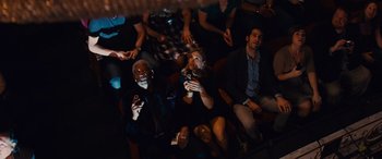 Movie still from “Now You See Me” (2013), directed by Louis Leterrier – A group of people sitting in a room with remotes; Wide shot, Overhead angle