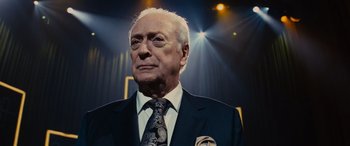 Movie still from “Now You See Me” (2013), directed by Louis Leterrier – An older man wearing a suit and tie; Close Up shot, Low angle