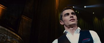 Movie still from “Now You See Me” (2013), directed by Louis Leterrier – A man in a white shirt and black vest looking up; Close Up shot, Low angle