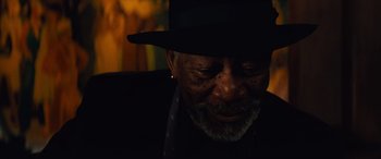 Movie still from “Now You See Me” (2013), directed by Louis Leterrier – An older man wearing a black hat and smiling; Close Up shot, Low angle