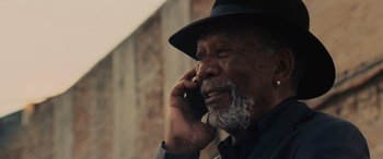 Movie still from “Now You See Me” (2013), directed by Louis Leterrier – An older man talking on a cell phone; Close Up shot, Low angle