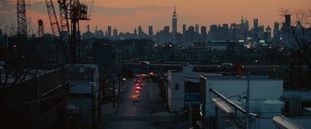 Movie still from “Now You See Me” (2013), directed by Louis Leterrier – A view of a city at night with a view of the empire state building in the distance; Extreme Wide shot, High angle