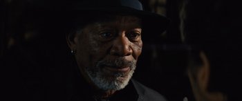 Movie still from “Now You See Me” (2013), directed by Louis Leterrier – An older man wearing a black hat and a black shirt; Close Up shot, Over the shoulder angle