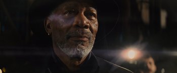 Movie still from “Now You See Me” (2013), directed by Louis Leterrier – An older man wearing a black hat looking into the distance; Close Up shot, Low angle