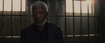 Movie still from “Now You See Me” (2013), directed by Louis Leterrier – An older man standing in front of a metal fence; Close Up shot, Low angle