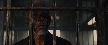 Movie still from “Now You See Me” (2013), directed by Louis Leterrier – An older man in a jail cell looking at the camera through the bars; Close Up shot, High angle