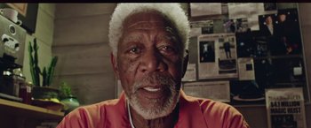 Movie still from “Now You See Me 2” (2016), directed by Jon M. Chu – An older man with white hair and a red shirt; Close Up shot, Overhead angle