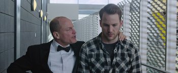 Movie still from “Now You See Me 2” (2016), directed by Jon M. Chu – A man with a bow tie is standing next to another man who is standing next to him; Close Up shot, Low angle