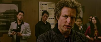 Movie still from “Now You See Me 2” (2016), directed by Jon M. Chu – A person with curly hair; Close Up shot, Over the shoulder angle