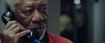 Movie still from “Now You See Me 2” (2016), directed by Jon M. Chu – An older man is holding something in his mouth; Close Up shot, Low angle