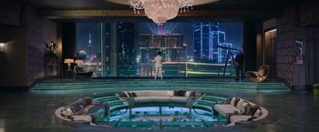Movie still from “Now You See Me 2” (2016), directed by Jon M. Chu – A man standing in front of a room with a chandelier; Extreme Wide shot, Over the shoulder angle