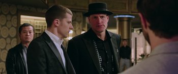 Movie still from “Now You See Me 2” (2016), directed by Jon M. Chu – A man in a black suit and a man in a black hat; Close Up shot, Over the shoulder angle