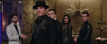 Movie still from “Now You See Me 2” (2016), directed by Jon M. Chu – A group of people standing next to each other in a room; Medium shot, Over the shoulder angle