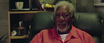 Movie still from “Now You See Me 2” (2016), directed by Jon M. Chu – An older man sitting in a chair in front of a bowl of fruit; Close Up shot, High angle