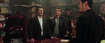 Movie still from “Now You See Me 2” (2016), directed by Jon M. Chu – A group of men standing at a bar singing; Medium shot, Low angle
