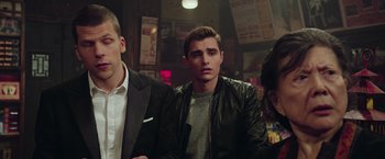 Movie still from “Now You See Me 2” (2016), directed by Jon M. Chu – A man in a leather jacket standing next to another man in a suit; Medium shot, Over the shoulder angle