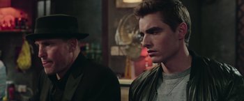 Movie still from “Now You See Me 2” (2016), directed by Jon M. Chu – A man in a hat and a man in a leather jacket; Close Up shot, Over the shoulder angle