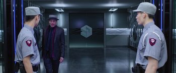 Movie still from “Now You See Me 2” (2016), directed by Jon M. Chu – A man standing in front of an entrance to a building; Wide shot, Low angle