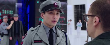 Movie still from “Now You See Me 2” (2016), directed by Jon M. Chu – A man in a uniform is standing in front of a building; Close Up shot, Low angle