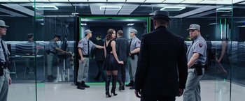 Movie still from “Now You See Me 2” (2016), directed by Jon M. Chu – A group of people standing in front of a mirror; Medium shot, Over the shoulder angle