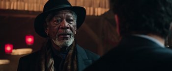 Movie still from “Now You See Me 2” (2016), directed by Jon M. Chu – An older man wearing a hat and a scarf; Close Up shot, Over the shoulder angle