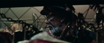 Movie still from “Now You See Me 2” (2016), directed by Jon M. Chu – An older man sitting in a car looking out the window; Close Up shot, Low angle