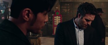 Movie still from “Now You See Me 2” (2016), directed by Jon M. Chu – Two men in suits talking to each other in a room; Close Up shot, Over the shoulder angle