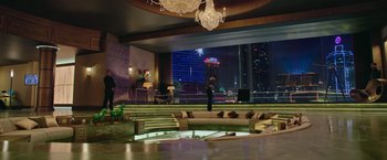 Movie still from “Now You See Me 2” (2016), directed by Jon M. Chu – A man standing on a bench in front of a large window; Extreme Wide shot, High angle