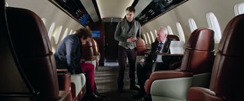 Movie still from “Now You See Me 2” (2016), directed by Jon M. Chu – A man standing on top of an airplane next to two other men; Wide shot, Over the shoulder angle