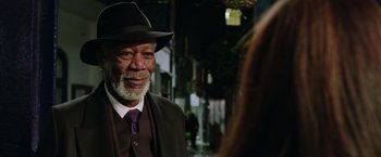 Movie still from “Now You See Me 2” (2016), directed by Jon M. Chu – An older man wearing a suit and a hat; Close Up shot, Over the shoulder angle